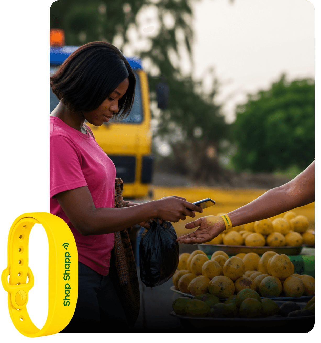 Customer paying a fruit vendor with a phone, wearing a yellow Shap Shapp band